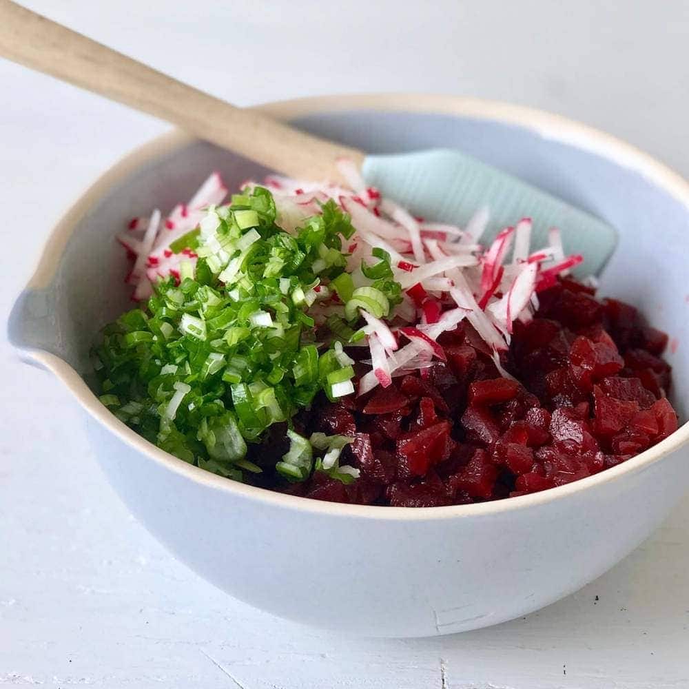 Pickled beet relish with scallions in a blue bowl