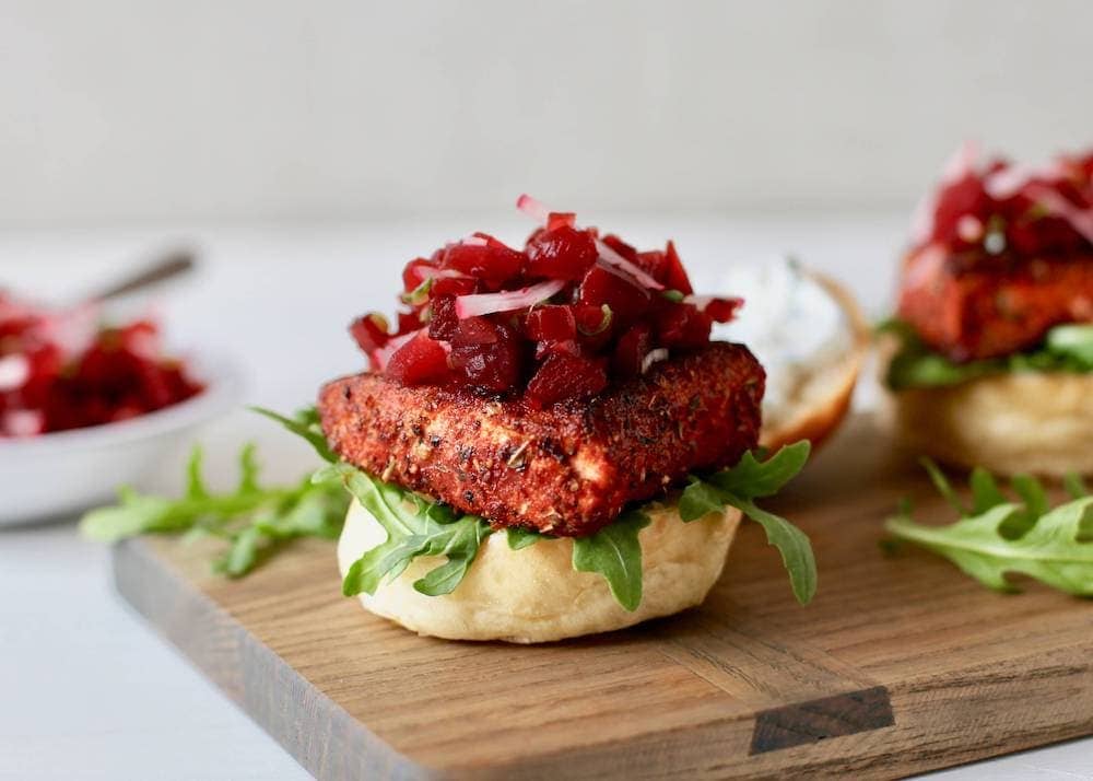 Blackened salmon sliders on a cutting board with beet relish