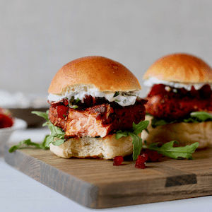 bite out of salmon slider on cutting board