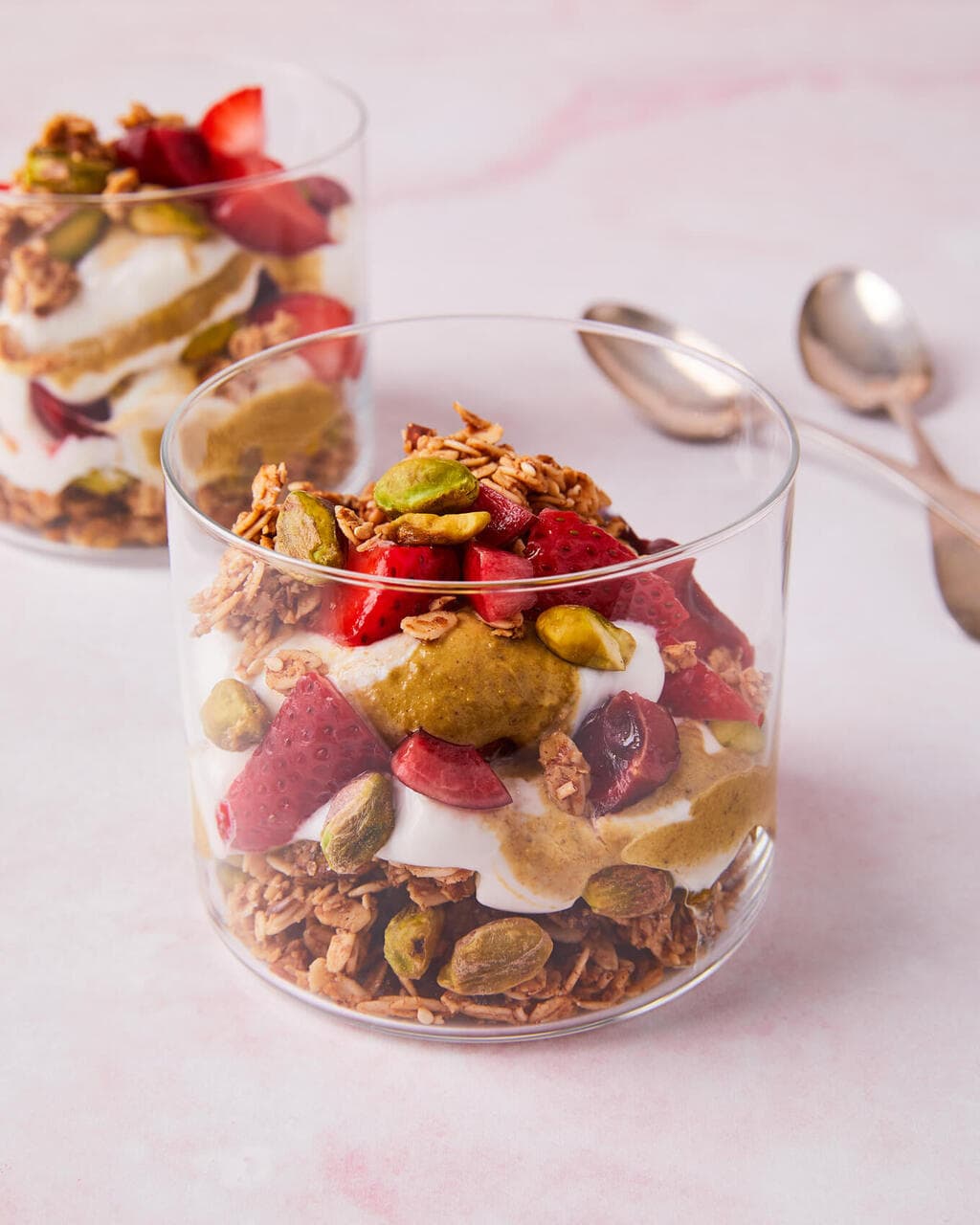 breakfast yogurt parfait with pistachio butter and red fruit