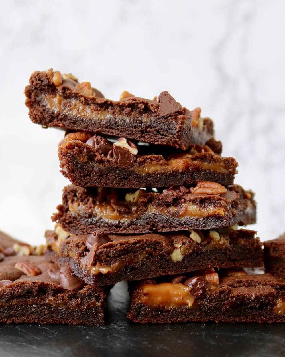 caramel chocolate brownies with pecans in a stack