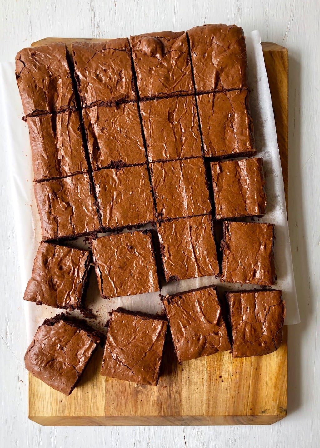 Cut brownies on parchment and cutting board