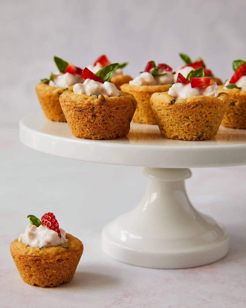 Soft basil sugar cookie cups with strawberry cottage cheese on a cake stand