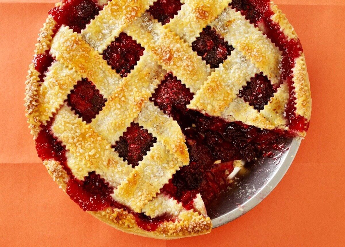 overhead view of a ginger razzleberry pie close up with a slice out