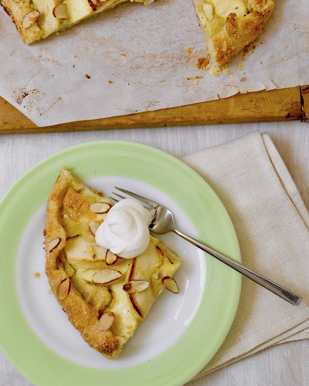 slice of apple tart with cream on a plate