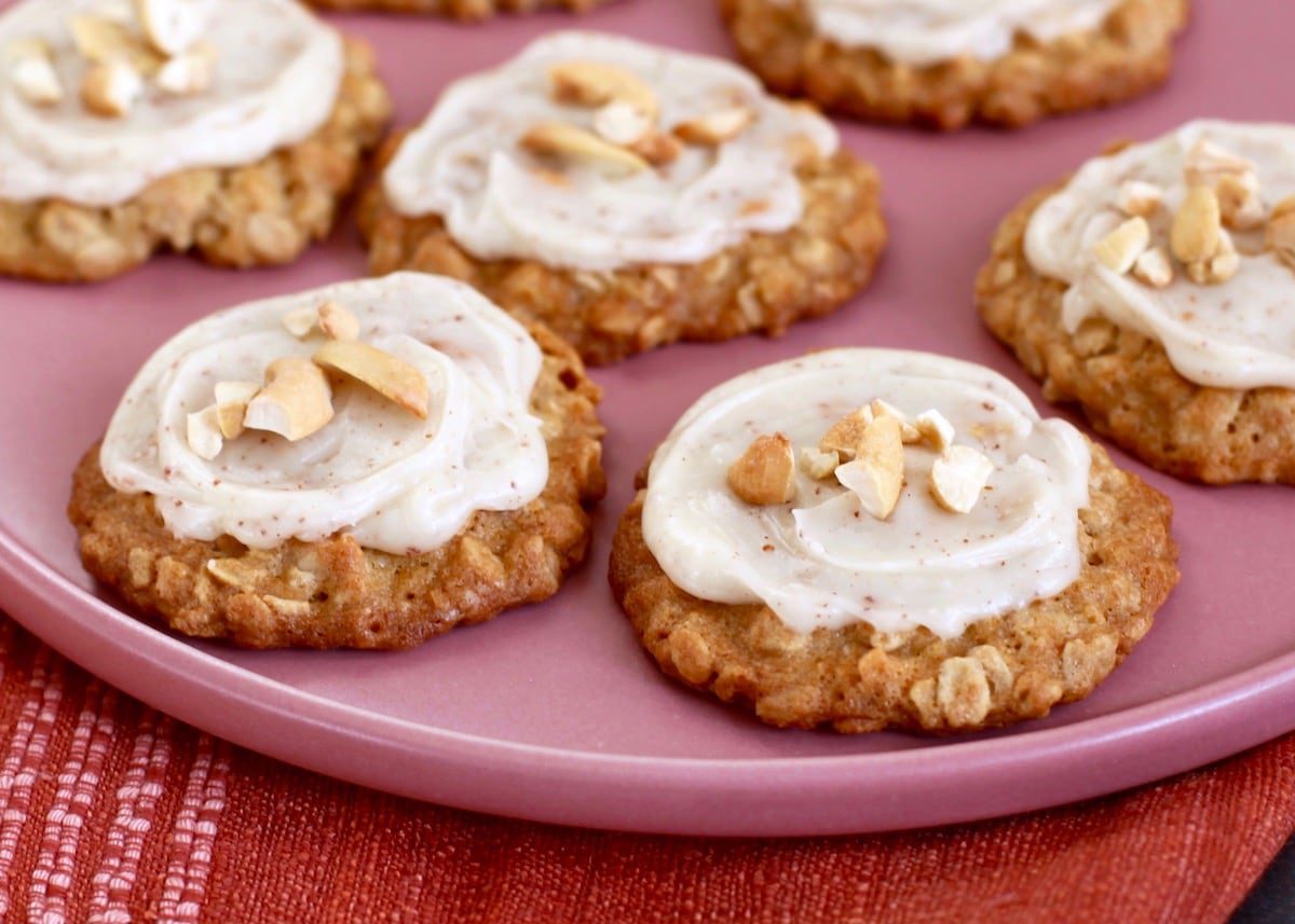 Cashew cookies with brown butter frosting on a pink plate