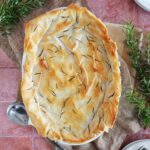Overhead view of a chicken spinach casserole topped with phyllo dough.
