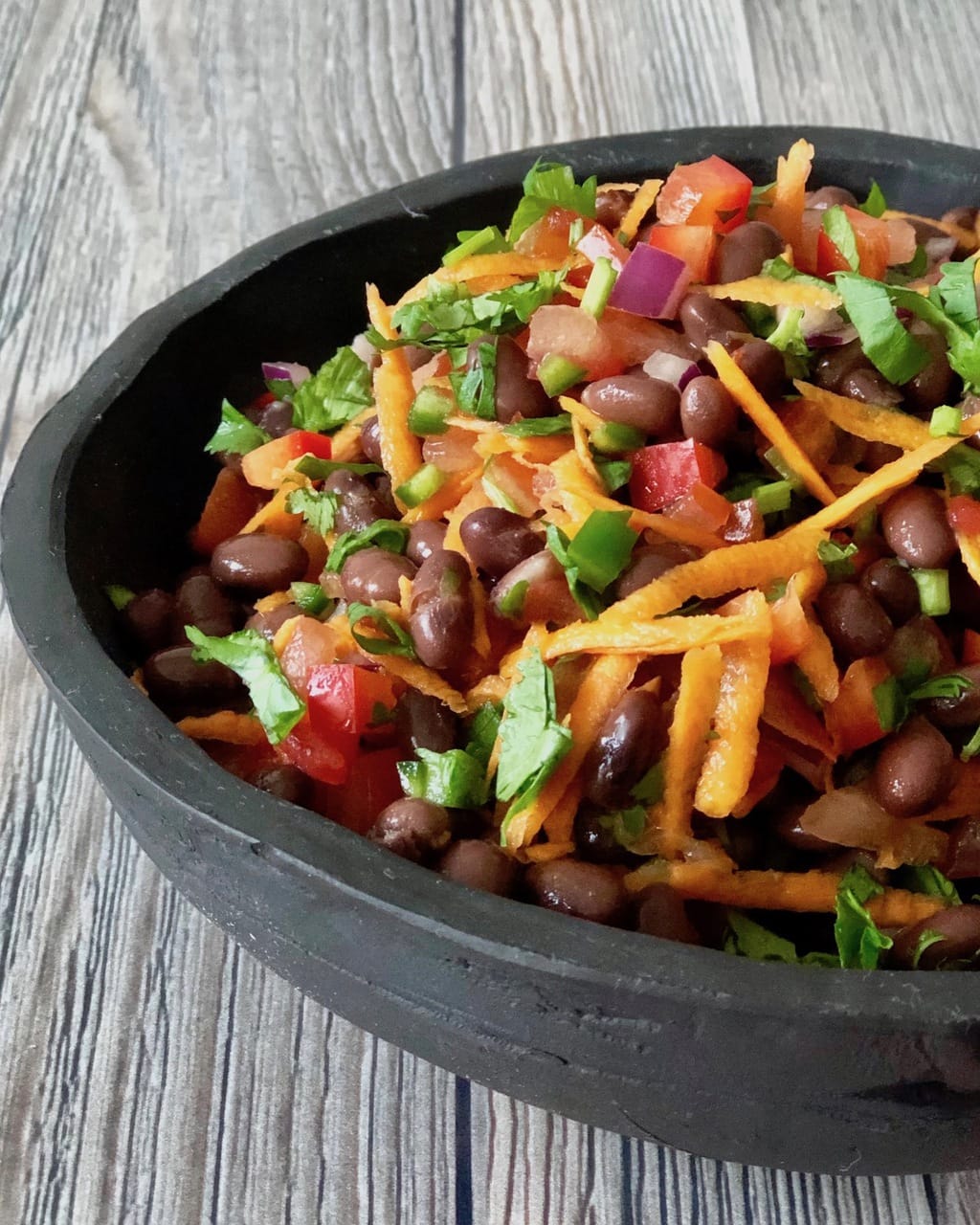 Healthy Taco Salad with black beans shredded carrots and cilantro in a bowl