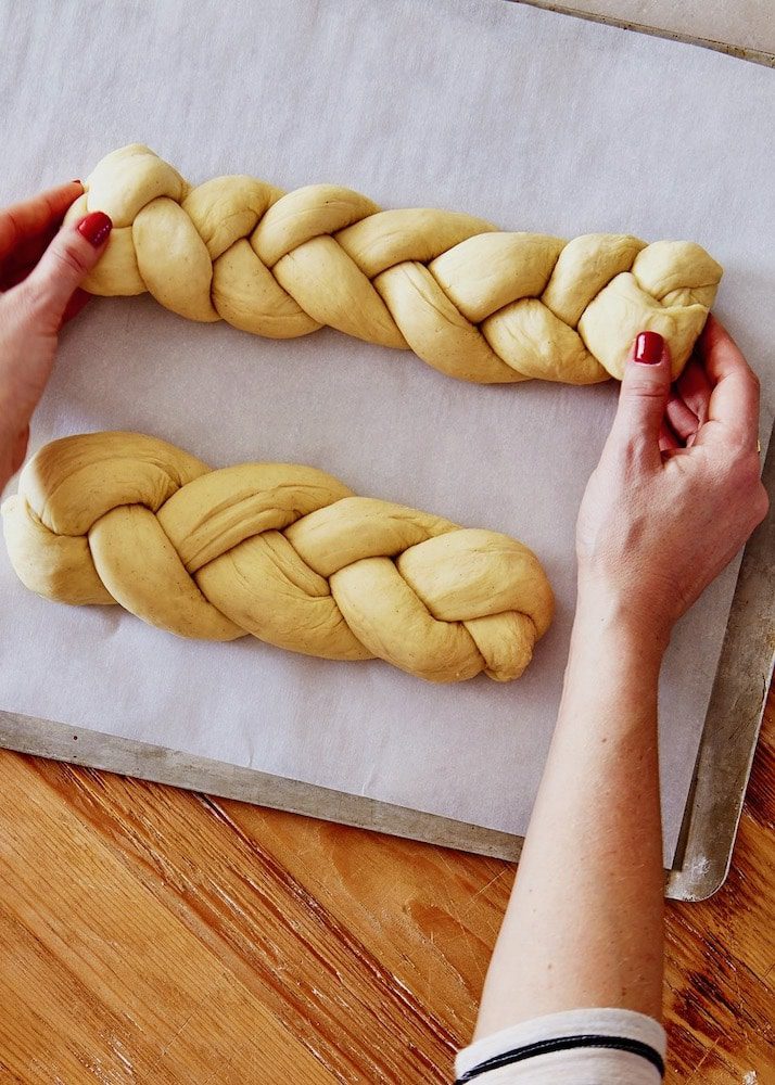 Braided pulla bread loaves on baking sheet