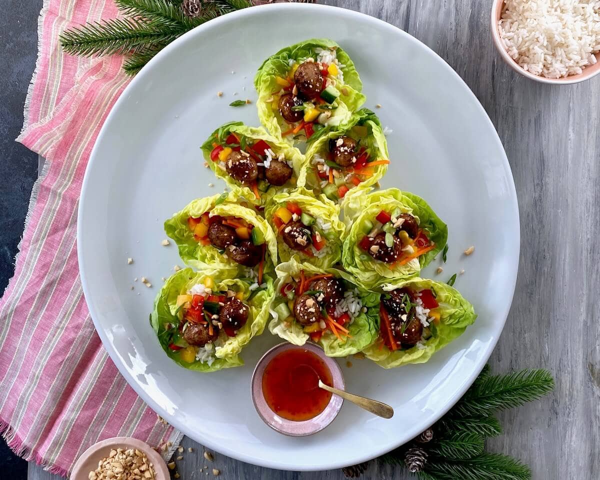 lettuce wrap shaped as christmas tree appetizer on white plate