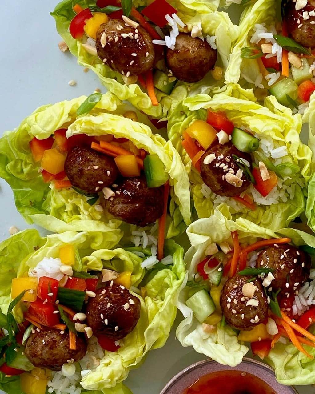 meatball lettuce wraps with chopped vegetables and rice