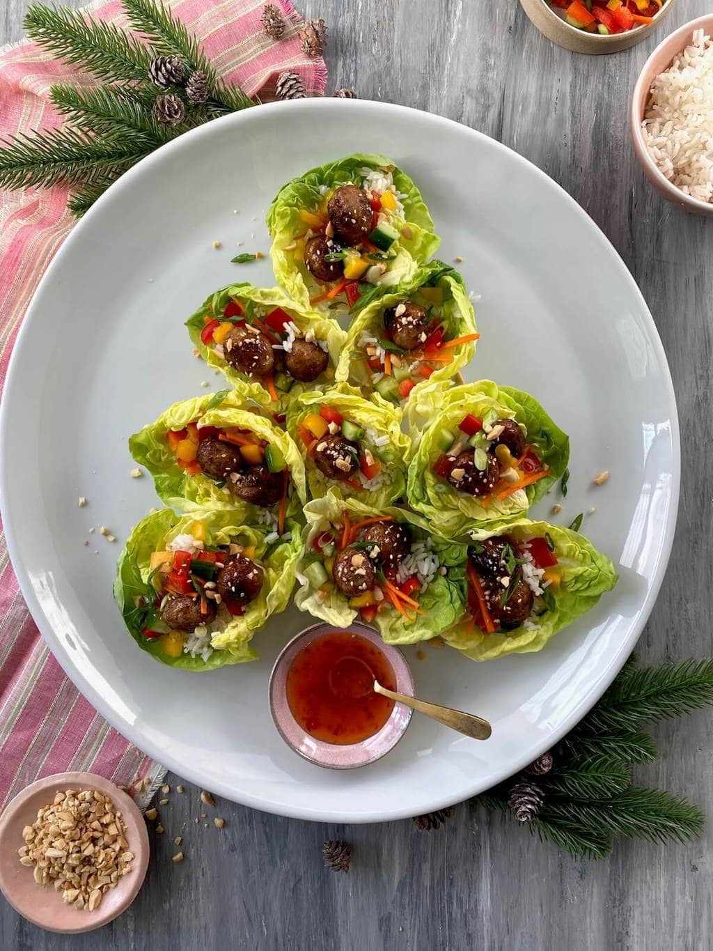 lettuce wraps with meatballs and asian flavors on white round platter