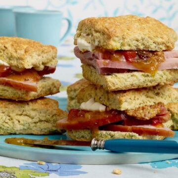 close up of biscuits with ham and chutney on blue plate