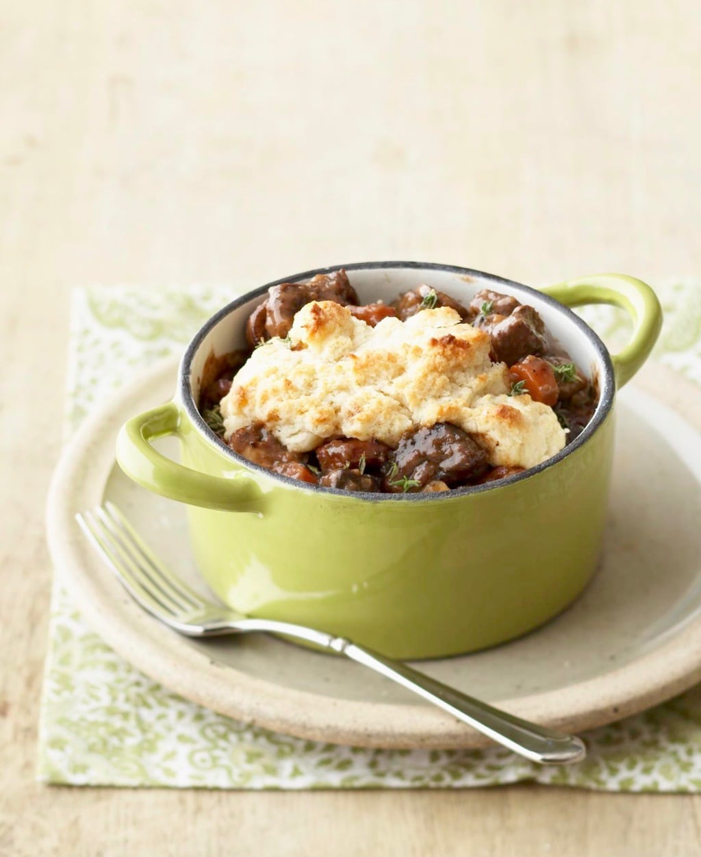 mini green pot with beef stew and biscuit topping