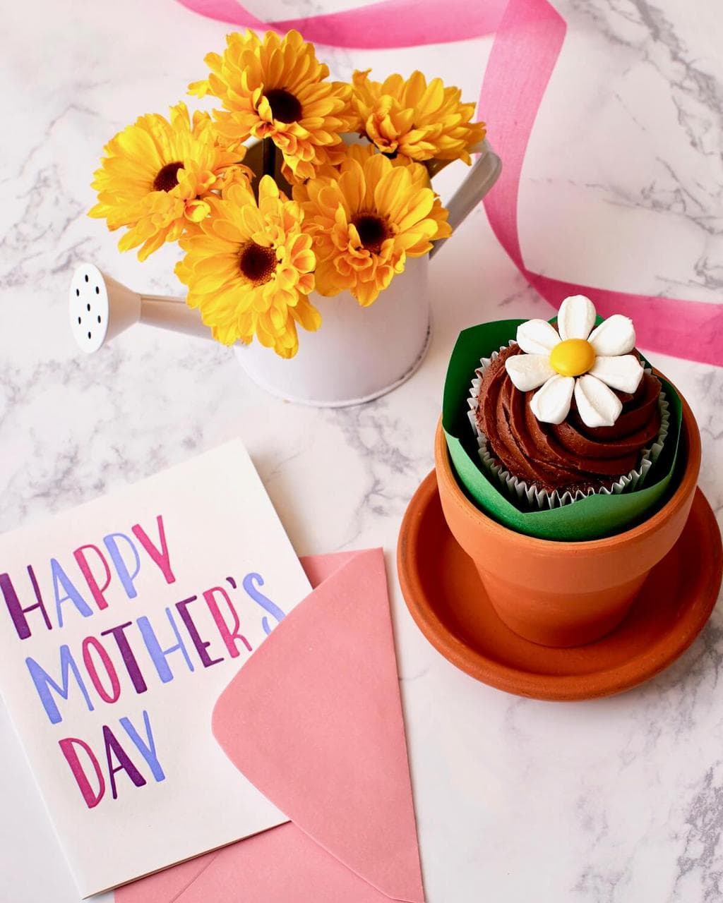 cupcake with marshmallow flower in a terra cotta pot with mothers day card