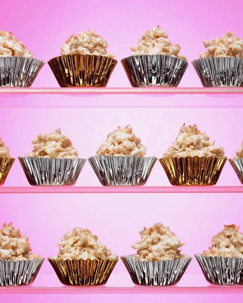 white chocolate candy haystacks in metallic cups on pink background
