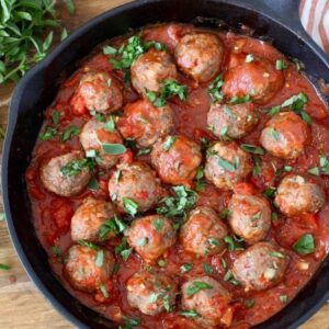Pesto and red pepper meatballs in cast iron skillet
