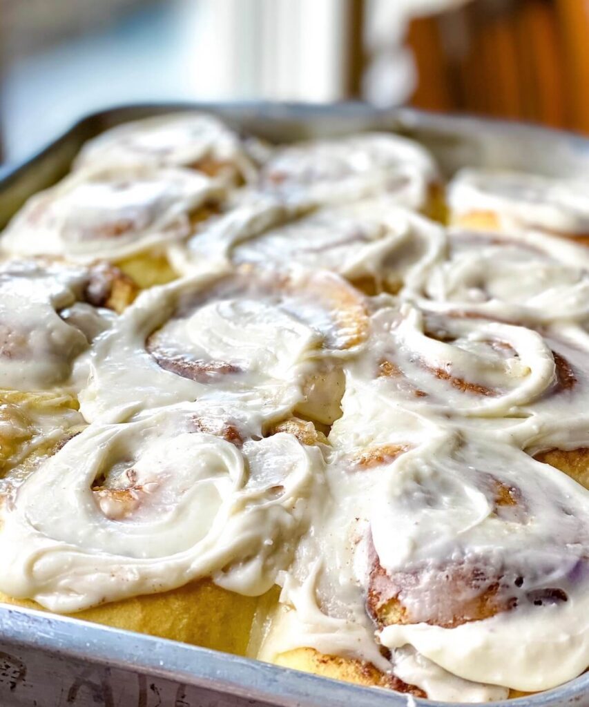 soft cinnamon rolls with frosting in pan