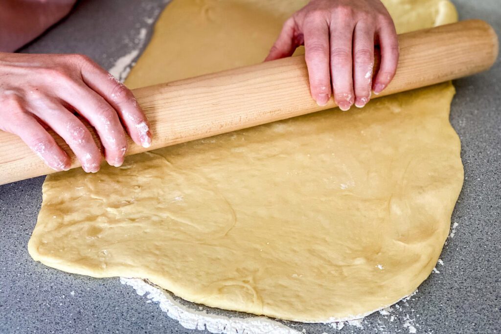 rolling dough with flour
