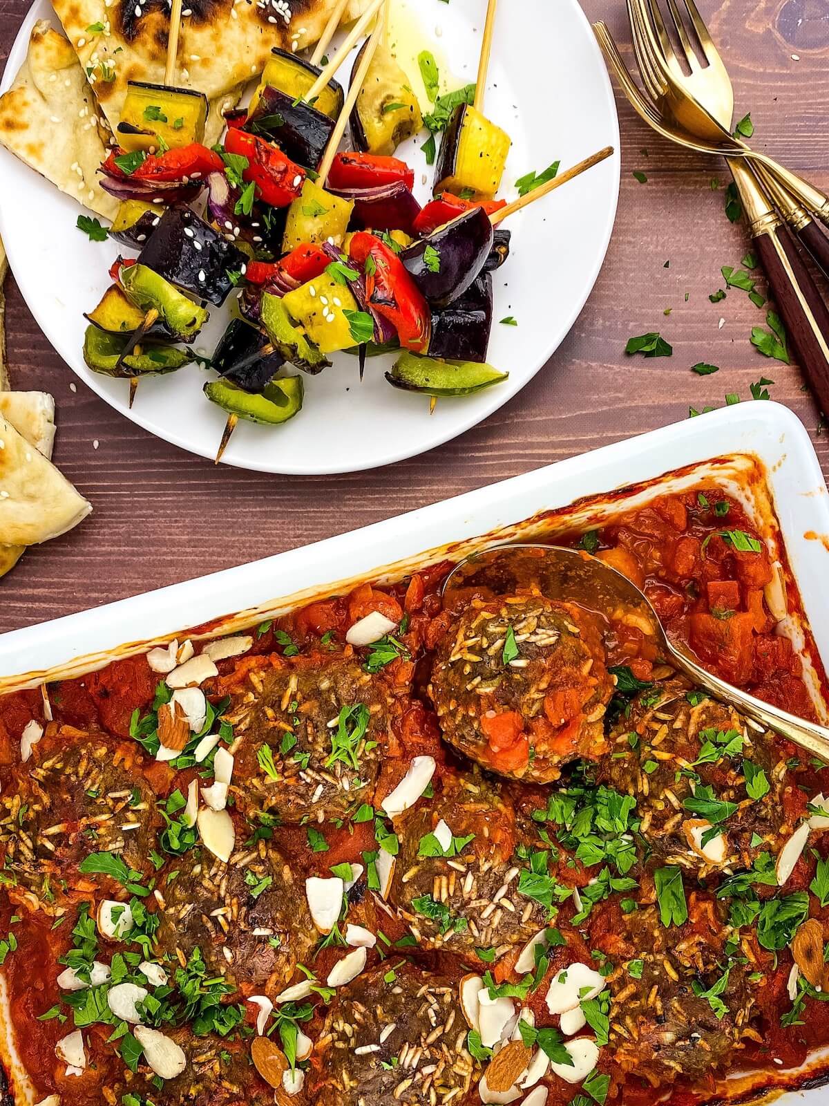 porcupine meatballs in baking dish with vegetable kabobs