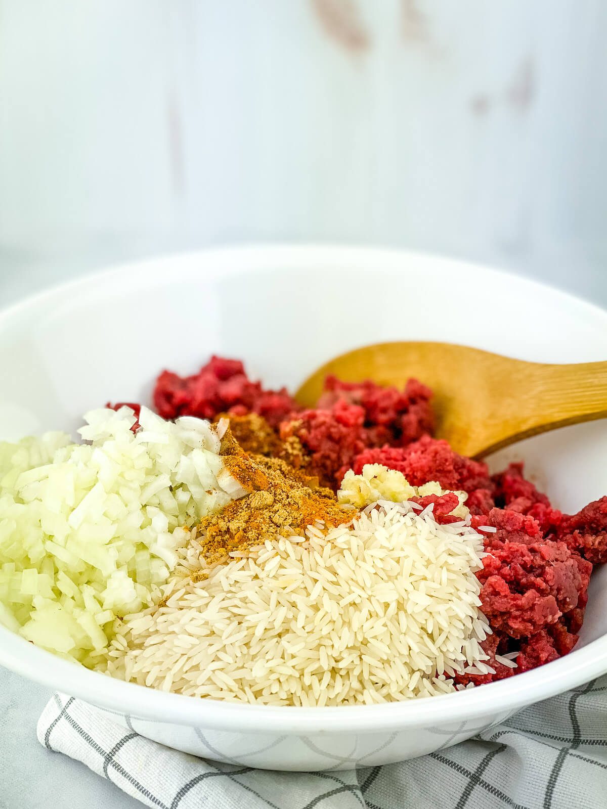 meatball ingredients in a large white bowl