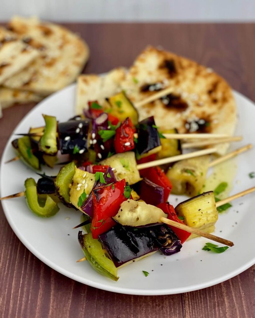 vegetable kababs with pita bread on plate