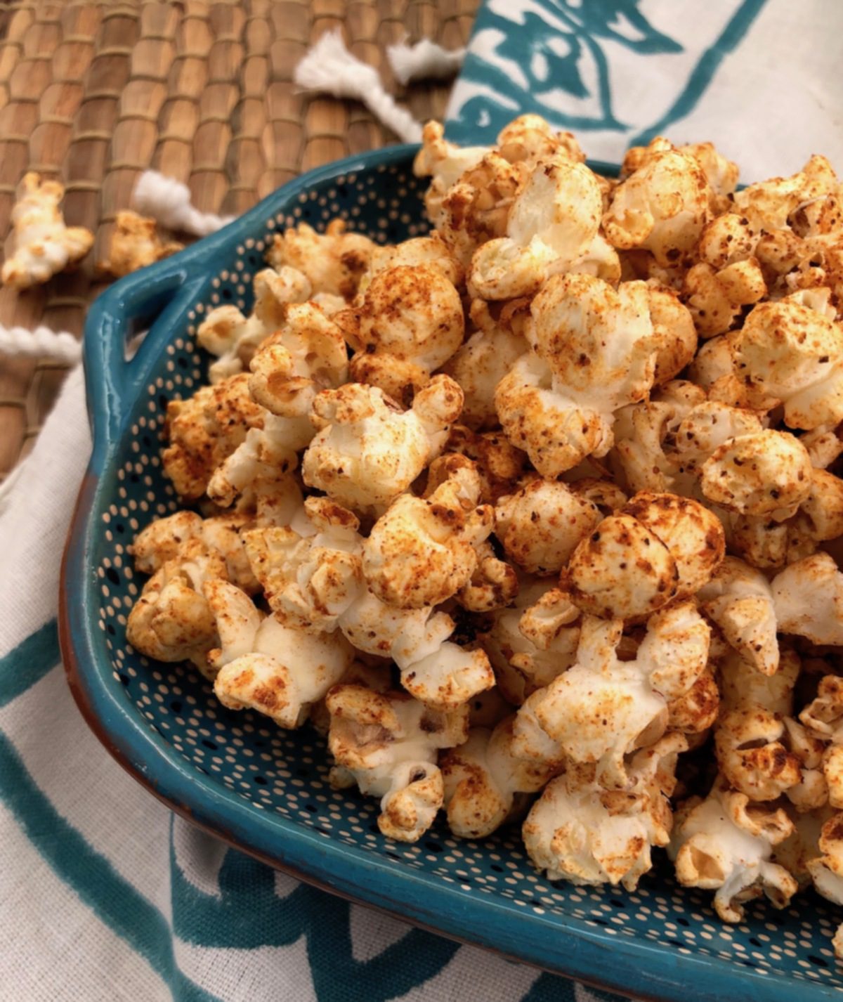 chili spiced popcorn in blue bowl with napkin