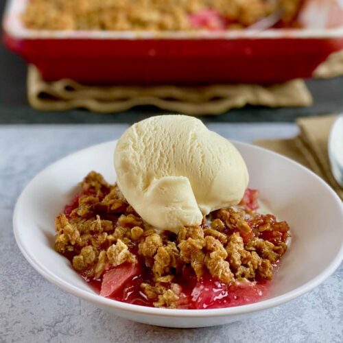 rhubarb crisp in bowl with ice cream