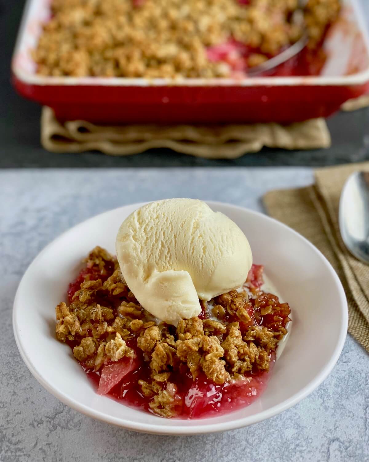 rhubarb crisp in bowl with ice cream