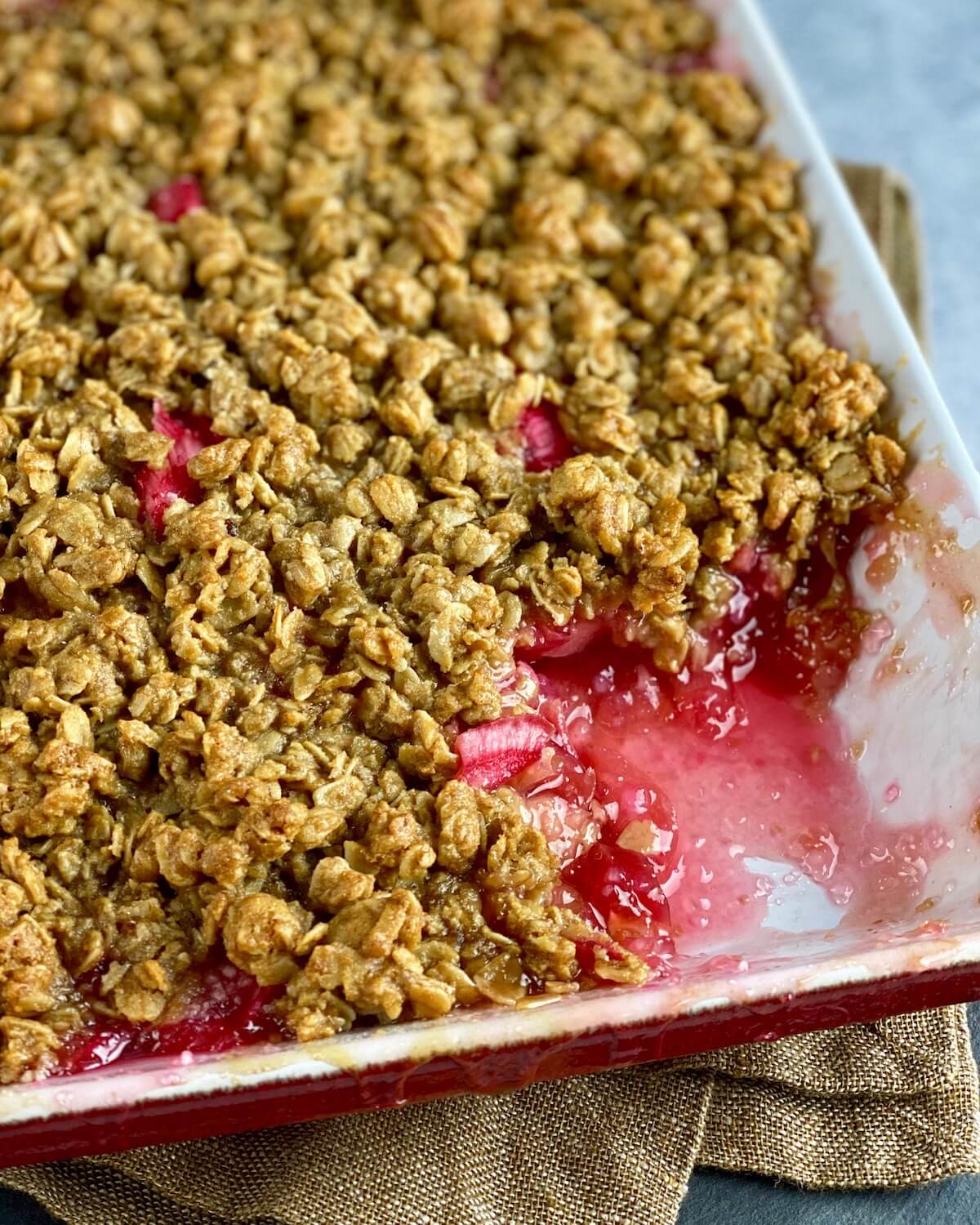 rhubarb with oat crisp scooped out of baking dish