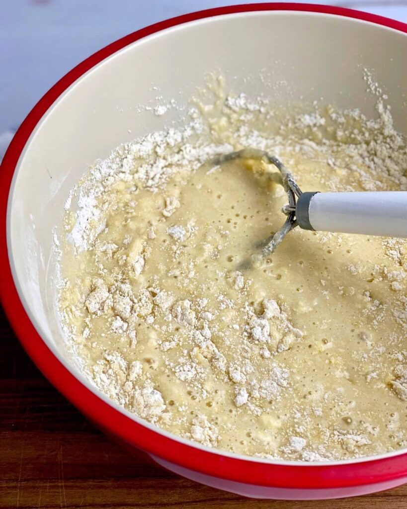 gluten free cornbread batter in red bowl