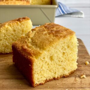 close up of slice of cornbread on board