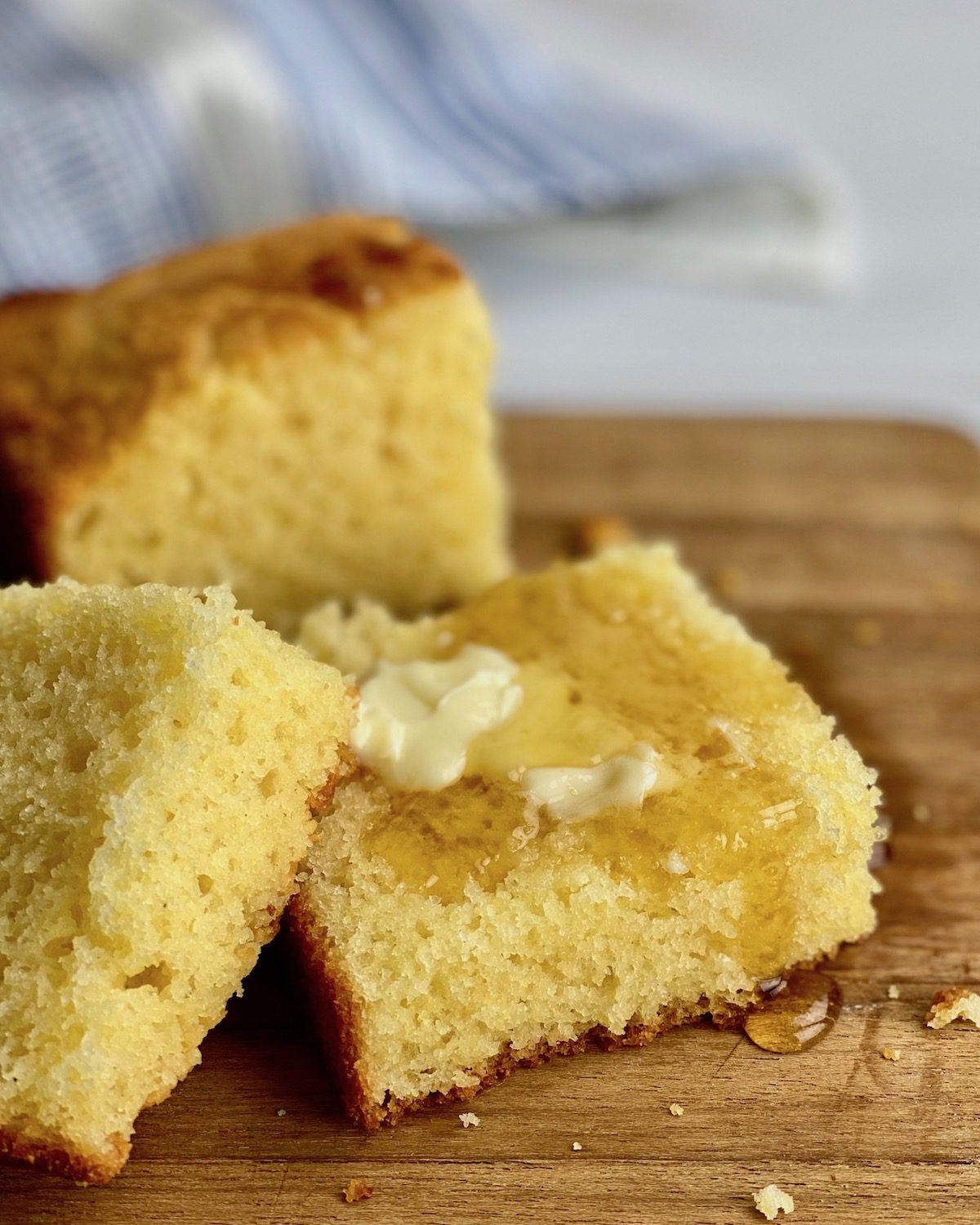close up of cornbread with butter and honey