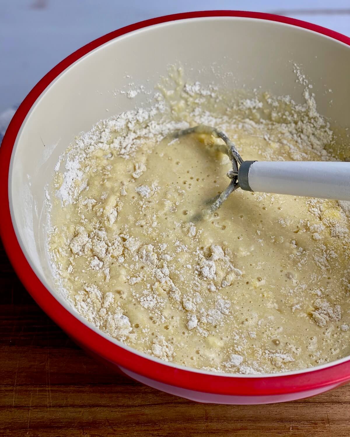 cornbread batter in red bowl