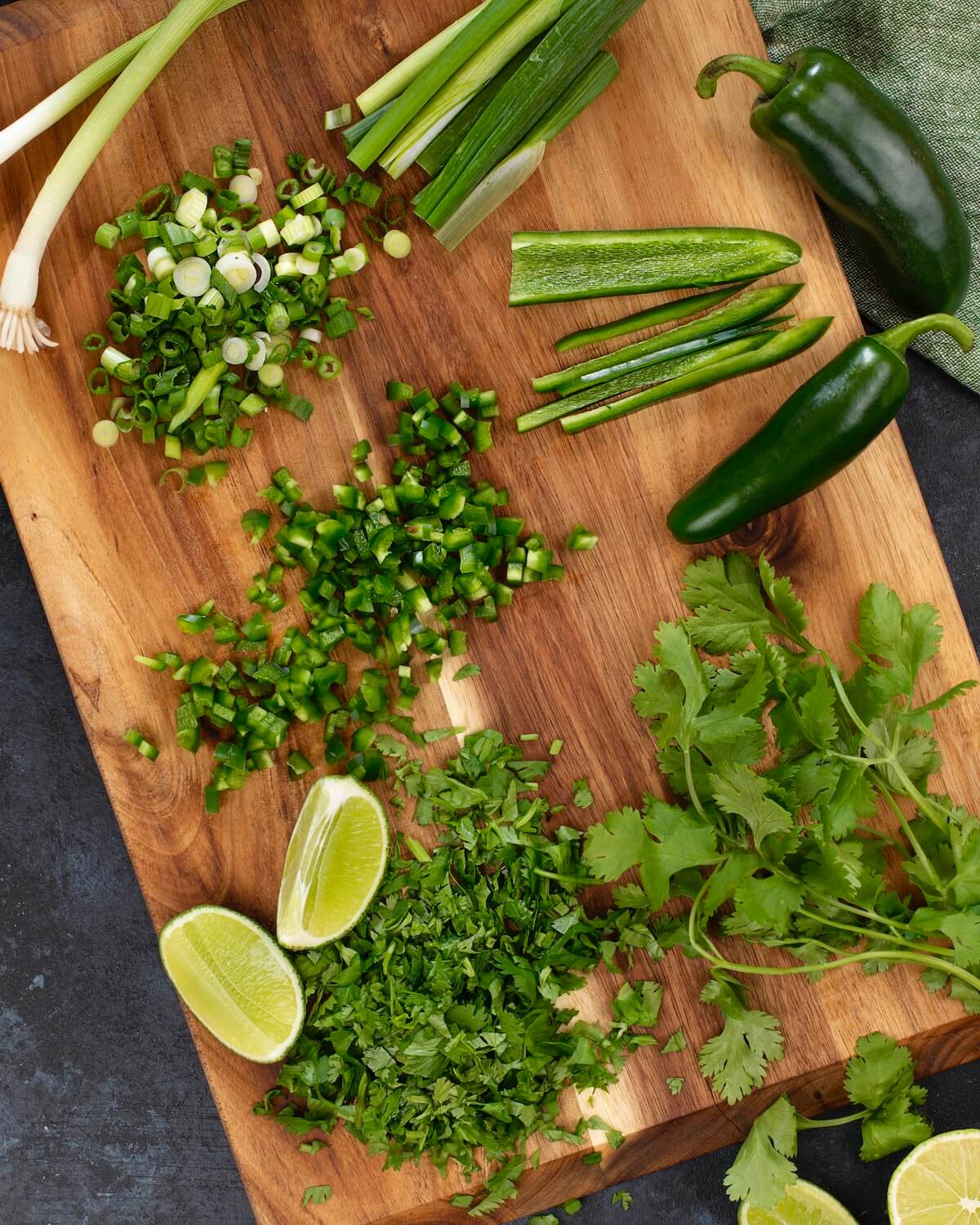 Ingredients for cilantro salsa on a wood cutting board