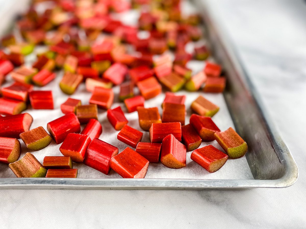 cut rhubarb on a baking sheet with parchment