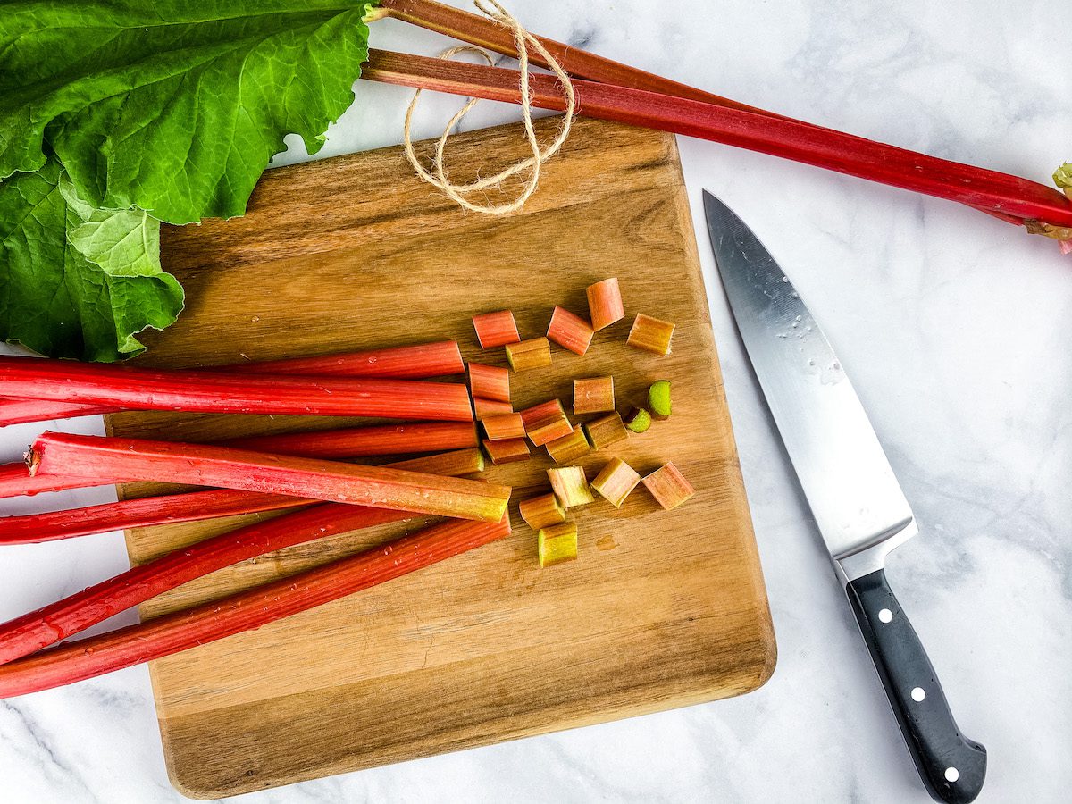 cutting rhubarb on a wood cutting board