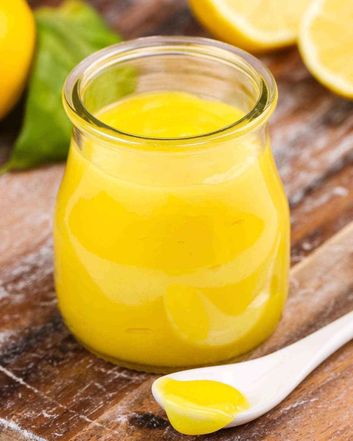 lemon curd in a jar with a scoop out