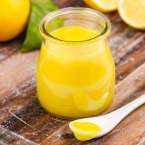 lemon curd in jar with spoonful out