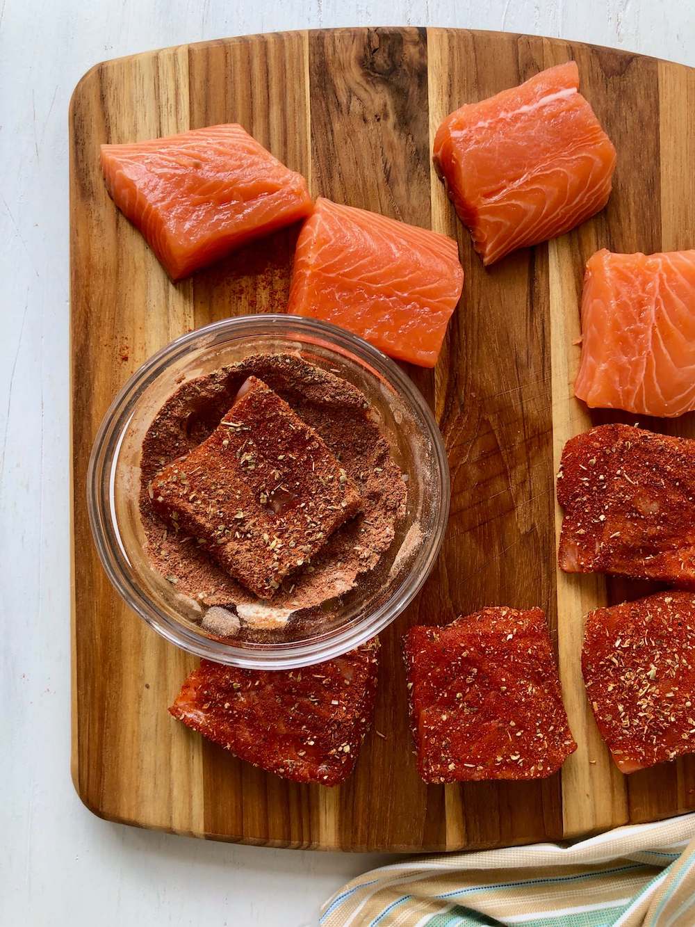 salmon on cutting board with spice rub