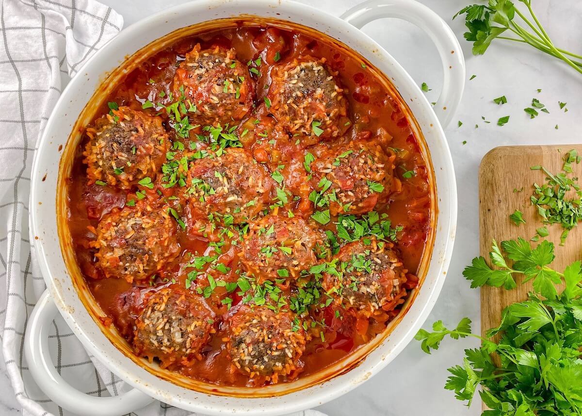 beef meatballs with rice in tomato sauce with fresh parsley on top