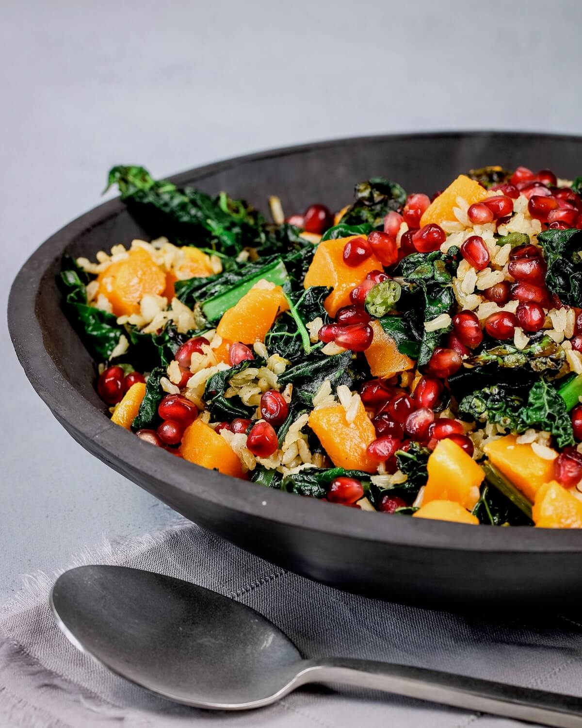 kale and squash salad with brown rice and pomegranates
