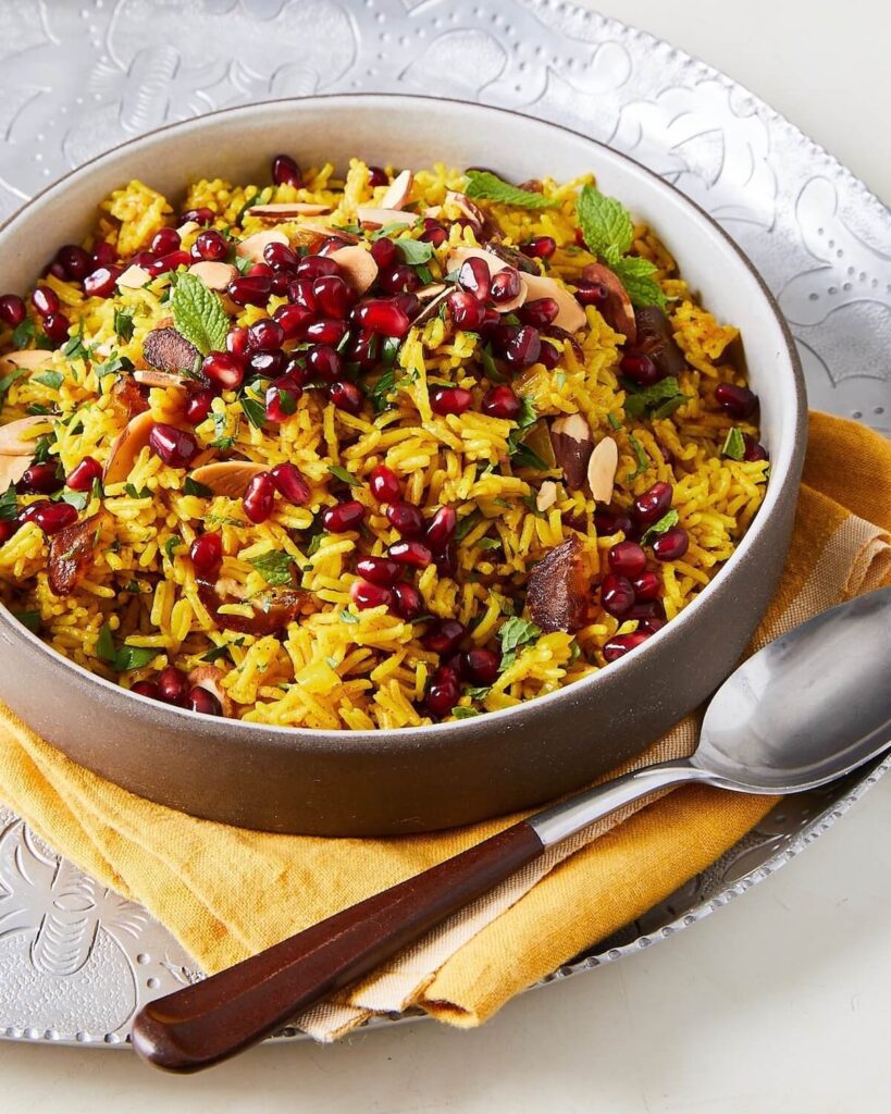 yellow rice side dish with dates and pomegranates