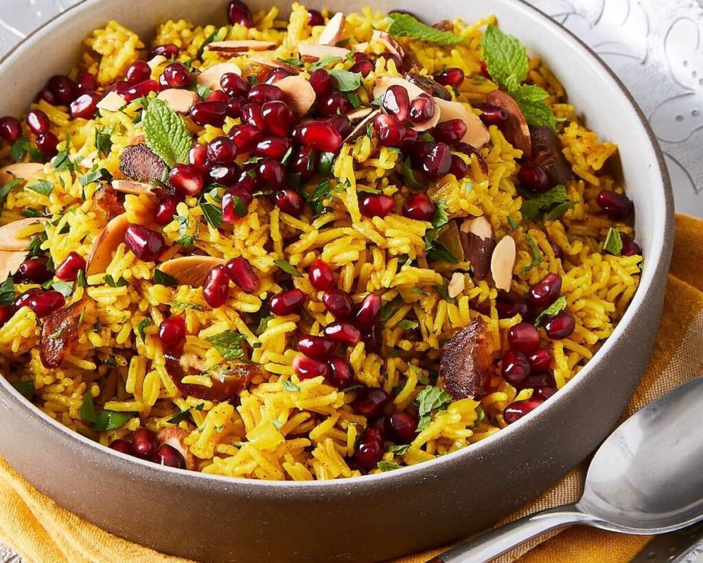 yellow Mediterranean rice with pomegranates in a ceramic dish