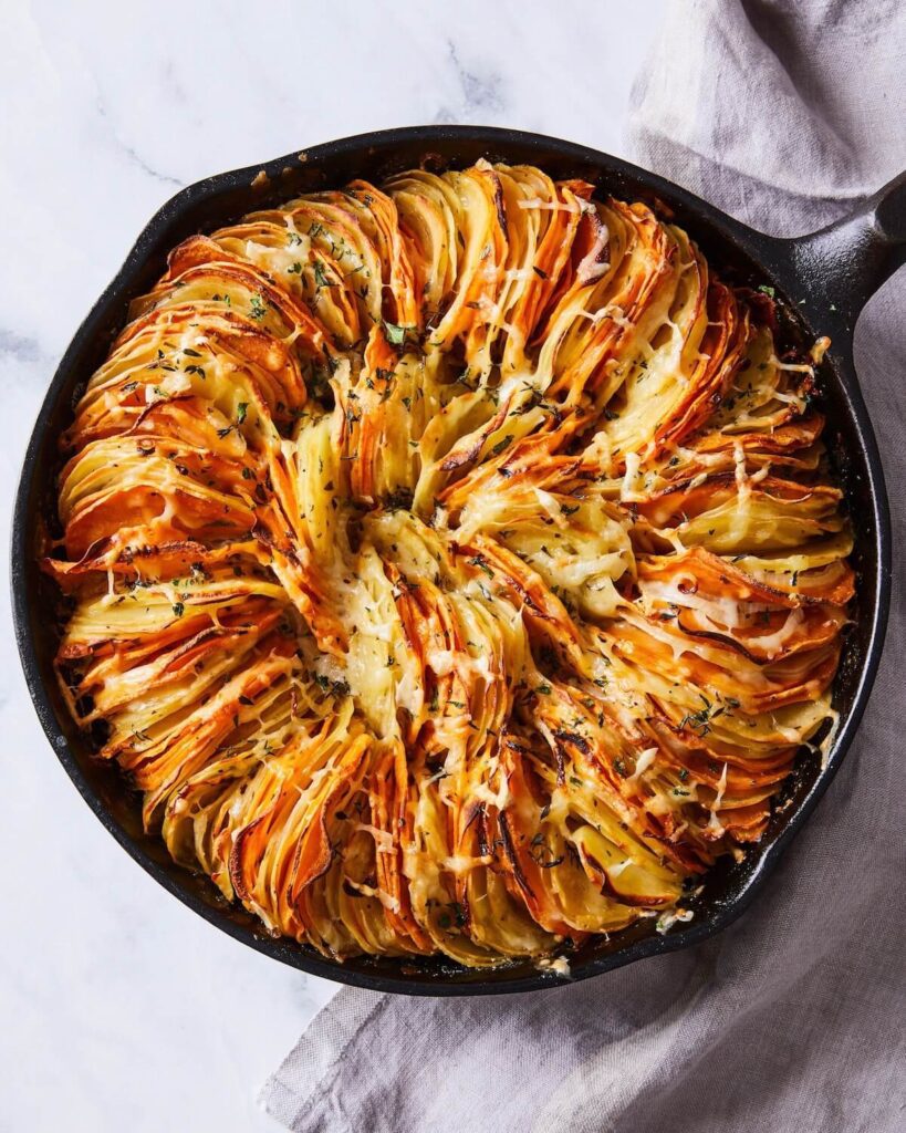 Overhead view of Gruyere potatoes au gratin in a cast iron skillet 