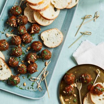 glazed meatballs with bread slices on a platter