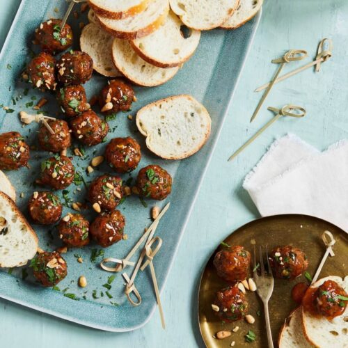 glazed meatballs with bread slices on a platter