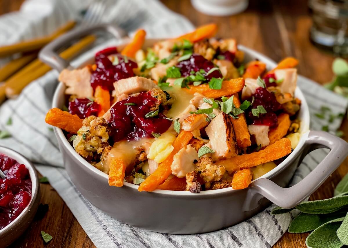 thanksgiving leftovers poutine on napkin in baking dish