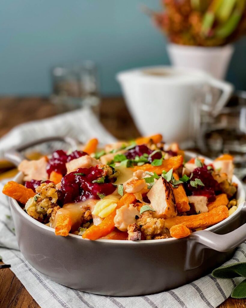 sweet potatoes poutine in baking dish with gravy boat