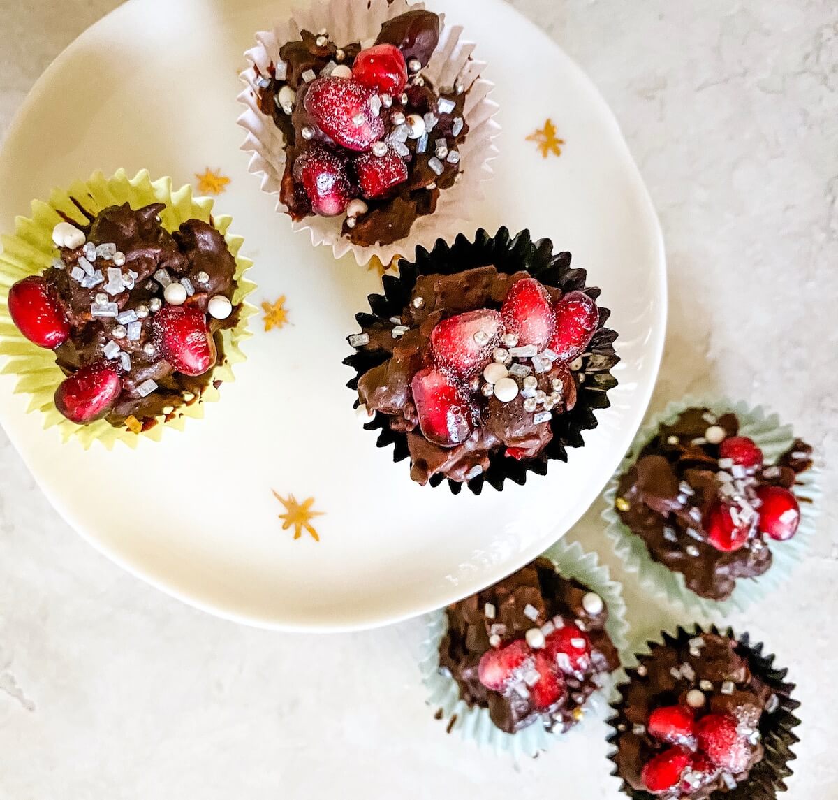 pomegranates and chocolate in candy cups from overhead